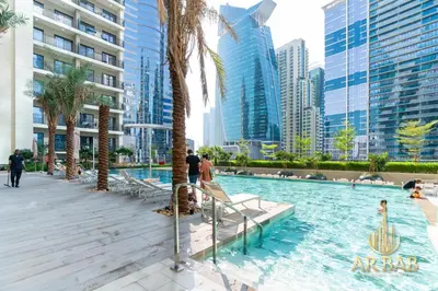 a swimming pool in a city with tall buildings at Arbab Homes Luxury 1BR- Canal View - Damac Zada Tower in Dubai