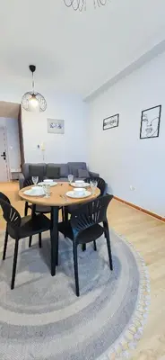 a dining room with a table and four chairs at Spacious Apartment Marina View in Dubai