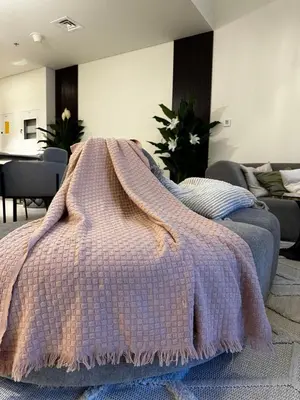 a bedroom with a purple blanket on a bed at Forte Downtown Dubai in Dubai