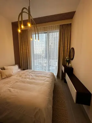 a bedroom with a large bed and a large window at Forte Downtown Dubai in Dubai