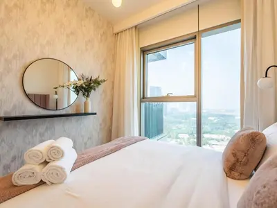 a hotel room with a large bed with a mirror at Spectacular 2BR in Downtown Views II in Dubai