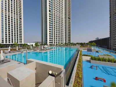 an overhead view of a large swimming pool with tall buildings at Spectacular 2BR in Downtown Views II in Dubai