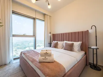 a bedroom with a large bed with a large window at Spectacular 2BR in Downtown Views II in Dubai