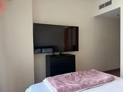 a bedroom with a bed and a mirror on the wall at Stylish Marina View Apartment in Dubai