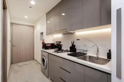 a kitchen with a sink and a washing machine at Modern studio in Azizi Riviera in Dubai