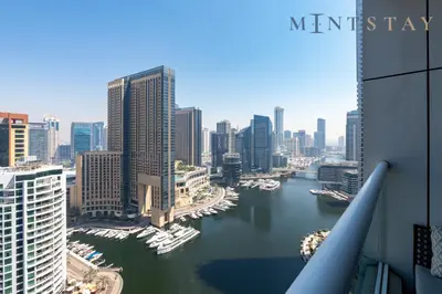 a view of a city with boats in the water at Continental Tower, Dubai Marina - Mint Stay in Dubai