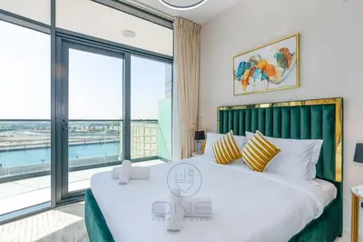 a bedroom with a large bed with a large window at 1BR Zada Tower l Two Balconies & City Views in Dubai