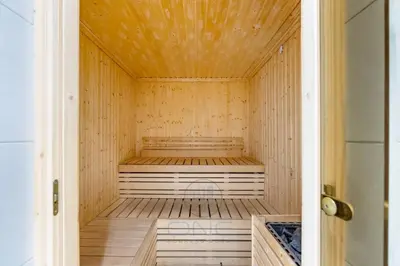 a wooden sauna with a bench inside of it at 1BR Zada Tower l Two Balconies & City Views in Dubai
