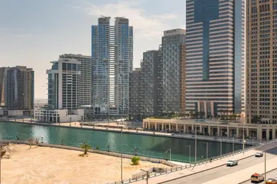 a view of a city with a river and buildings at 1BR Zada Tower l Two Balconies & City Views in Dubai