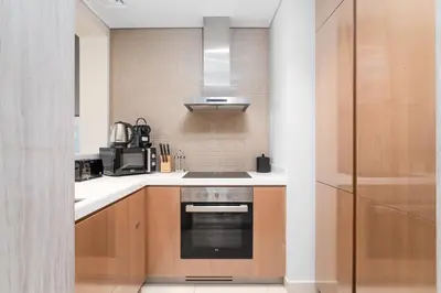 a kitchen with a sink and a stove at ALiving Classy 1BR I Paramount Towers, Business Bay- 6105 in Dubai