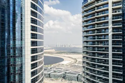 an aerial view of two tall buildings next to a beach at ALiving Classy 1BR I Paramount Towers, Business Bay- 6105 in Dubai