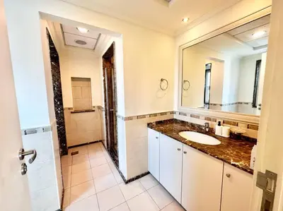 a bathroom with a sink and a large mirror at Golf Facing 5Bedroom Villa in Novelia Village in Dubai