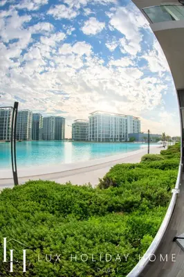 a view of the ocean from the balcony of a resort at LUX The District One Lagoon View Suite in Dubai