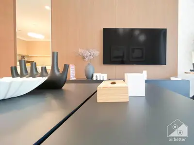 a living room with a table with a tv on it at Luxurious stay Dubai Creek Balcony & View in Dubai