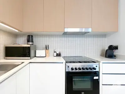 a kitchen with a stove top oven next to a microwave at Luxurious stay Dubai Creek Balcony & View in Dubai