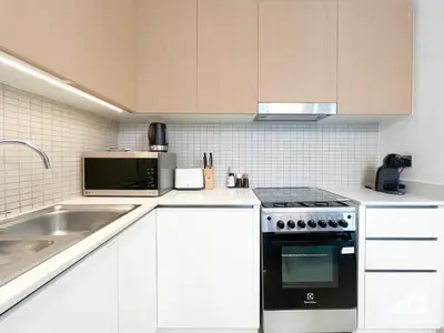 a kitchen with a sink and a stove top oven at Luxurious stay Dubai Creek Balcony & View in Dubai
