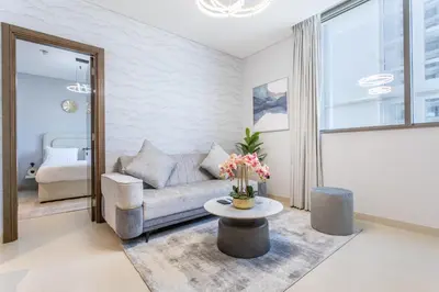 a living room with a couch and a table at STAY BY LATINEM Luxury 2BR Holiday Home CV A814 near Burj Khalifa in Dubai