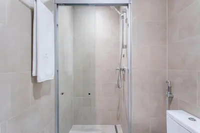 a shower with a glass door in a bathroom at STAY BY LATINEM Luxury 2BR Holiday Home CV A814 near Burj Khalifa in Dubai