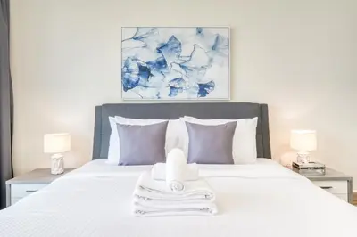a bedroom with a bed with a towel on it at Burj Residence 1, Downtown Dubai - Mint Stay in Dubai