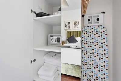 two pictures of a room with towels and a bathroom at StoneTree - Elegant Studio in Goldcrest View in Dubai