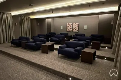 a waiting room with blue chairs and tables in a building at Oraya - Modern Apt 5 min walk to Dubai Mall & Burj Views in Dubai