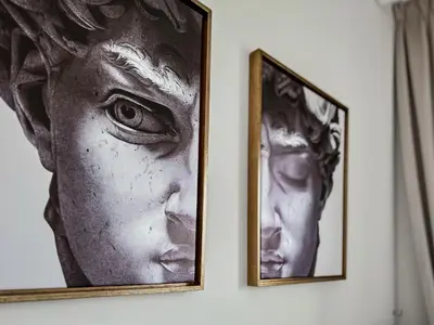 two black and white photographs hanging on a wall at Trophy - Cozy Elegant Suites in Dubai