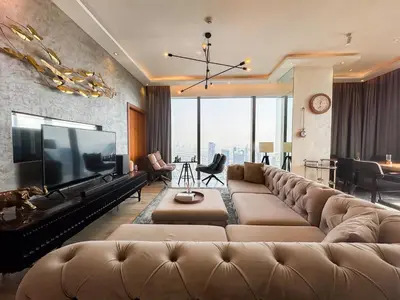 a living room with a large couch and a large television at High floor Luxury 2BR - Dubai Marina Gate in Dubai