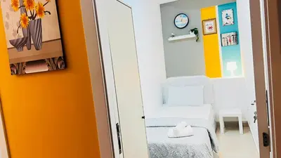 a small room with a white chair and a yellow wall at Glamorous Partition Room in Barsha 1 Near Metro in Dubai