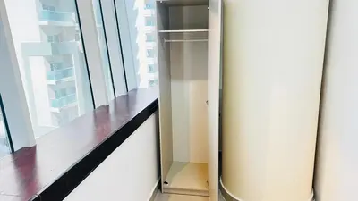 a glass refrigerator in a room with a window at Partition Room With Window Near MOE Metro in Dubai
