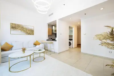 a living room with a couch and a table at Luxury 1 Bedroom Full Marina View, Sleeps 6, 1 Min to Metro in Dubai