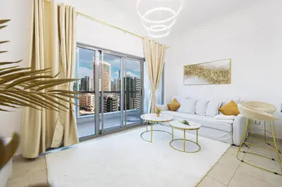 a living room with a couch and a large window at Luxury 1 Bedroom Full Marina View, Sleeps 6, 1 Min to Metro in Dubai