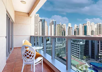 a balcony with a chair and a view of a city at Luxury 1 Bedroom Full Marina View, Sleeps 6, 1 Min to Metro in Dubai