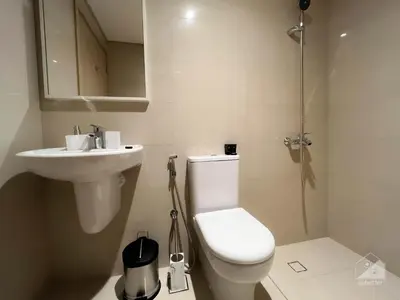 a white bathroom with a toilet and a sink at Luxurious Apt with breathtaking view in Downtown in Dubai