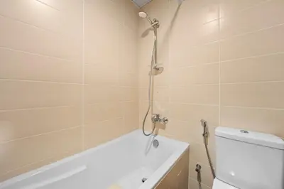 a bathroom with a shower and a toilet and a bath tub at Studio in Dubai