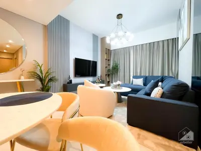 a living room with a blue couch and a table at Majestic 2Bedroom in Burj Royale Downtown in Dubai