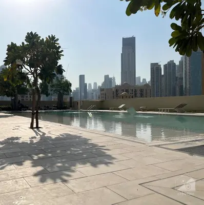 a swimming pool with a city skyline in the background at Majestic 2Bedroom in Burj Royale Downtown in Dubai