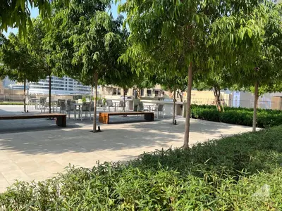 a park with benches and tables and trees at Majestic 2Bedroom in Burj Royale Downtown in Dubai