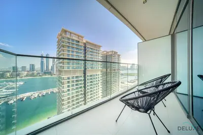 a chair on a balcony with a view of a city at Inviting 1BR at Beach Vista Tower 1 Emaar Beachfront Dubai Marina by Deluxe Holiday Homes in Dubai
