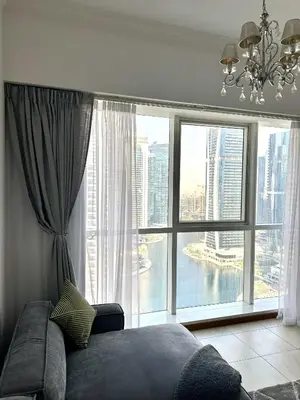 a bedroom with a large window with a view of the city at Jumeriah Lake Tower(JLT)- (MAG214)(2) in Dubai
