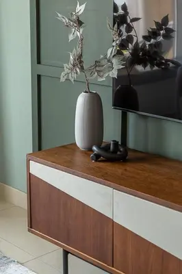 a vase sitting on top of a cabinet with a tv at Frank Porter - 29 Boulevard in Dubai