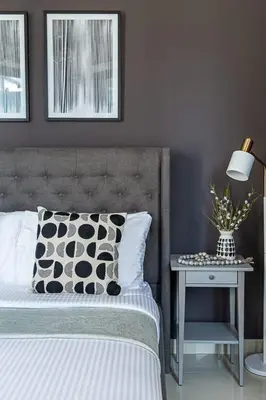 a bedroom with a bed and a table with a lamp at Frank Porter - 29 Boulevard in Dubai
