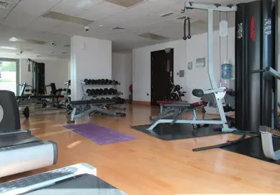 a gym with several treadmills and machines in a room at Frank Porter - 29 Boulevard in Dubai