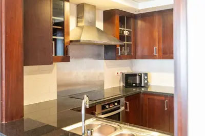 a kitchen with a sink and a stove top oven at Bella Vista - 29 Boulevard Downtown - 2BR - Partial Fountain View in Dubai