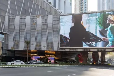 a large billboard on the side of a building at Frank Porter - Reva Residences in Dubai