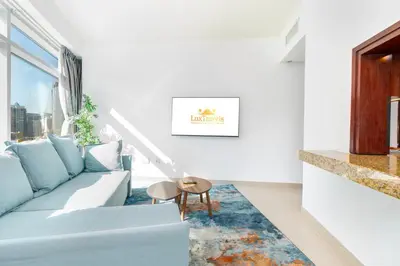 a living room with a couch and a table at Lux BnB Burj Views Tower I Downtown in Dubai