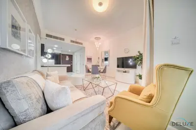 a living room with a couch and a table at Chic 1BR at The Signature Downtown Dubai by Deluxe Holiday Homes in Dubai