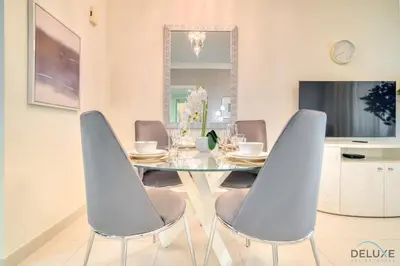 a dining room with a glass table and chairs at Chic 1BR at The Signature Downtown Dubai by Deluxe Holiday Homes in Dubai