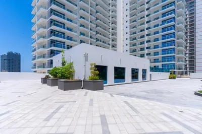 a building in front of some tall buildings at Studio with Balcony Skyline View Business Bay in Dubai