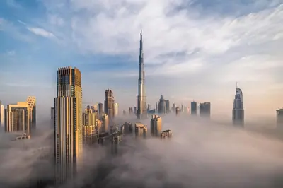 a foggy city with a lot of tall buildings at Staybridge Suites Dubai Business Bay by IHG in Dubai
