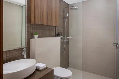 a bathroom with a toilet and a sink and a shower at Staybridge Suites Dubai Business Bay by IHG in Dubai